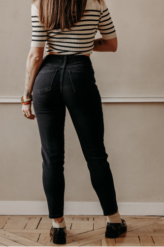 femme de dos qui porte un jean mom noir avec poches