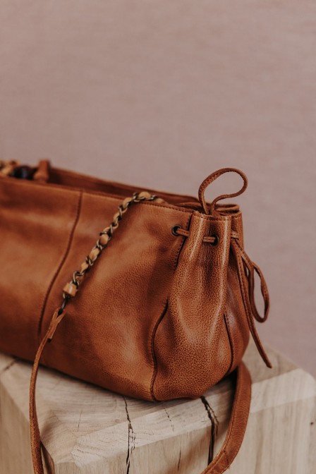 Sac en cuir posé sur une stèle.
